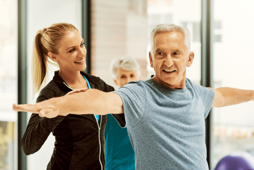 Elderly Man with fitness instructor