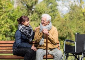 Caring for elderly man in the park