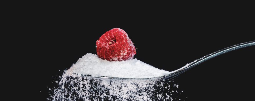 Raspberry sitting in sugar