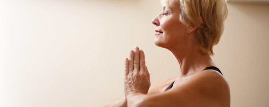 Elderly woman practising yoga