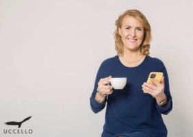 Elderly woman with cup of tea and phone