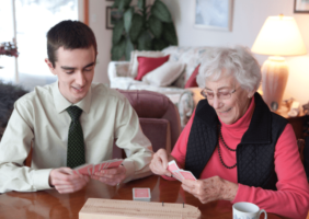 Grandson playing cards with grandmother